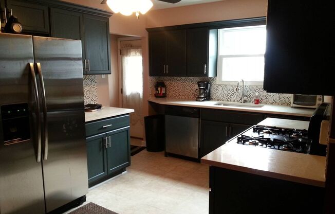 Modern 2 Bed/1 Bath row house with off-street parking!