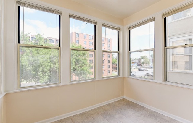 vacant sunroom with hardwood floors and large windows at twin oaks apartments columbia heights washington dc