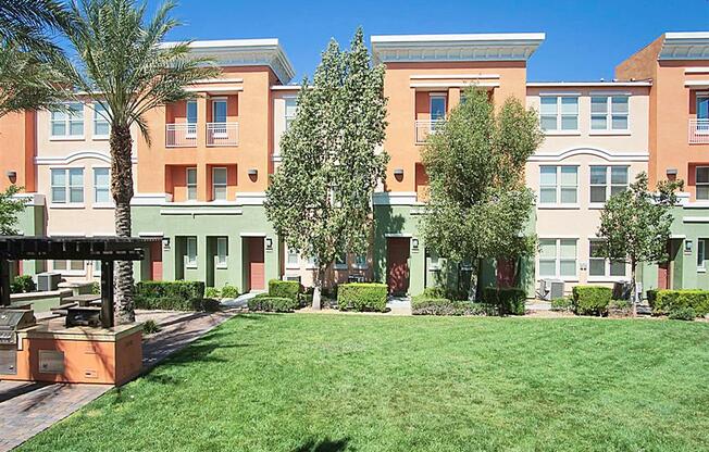 Outdoor courtyard with trees and grilling area at The Croix Townhomes in Henderson, NV offers 2 and 3 bedroom Townhomes!