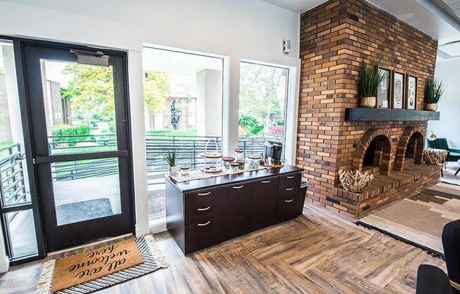 A modern interior with a brick fireplace and a kitchen island.