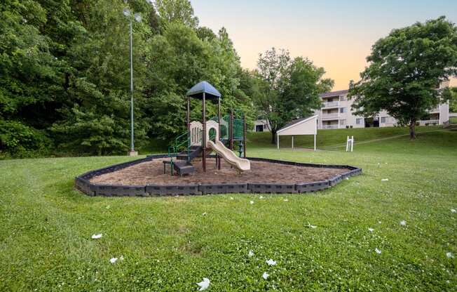 a playground with a swing set in a park