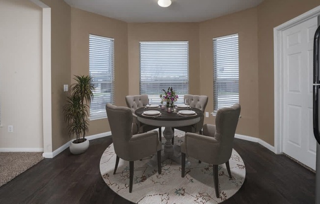 a dining room with a table and chairs