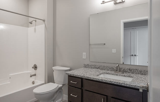 a bathroom with a toilet sink and shower