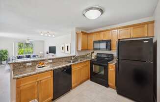 a kitchen with black appliances and granite counter tops