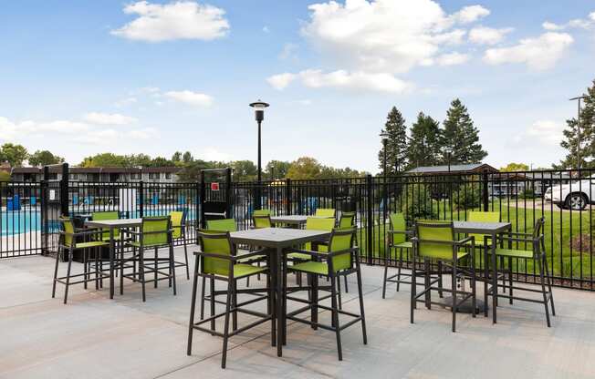 Hightop tables outside Villages on McKnight Apartments