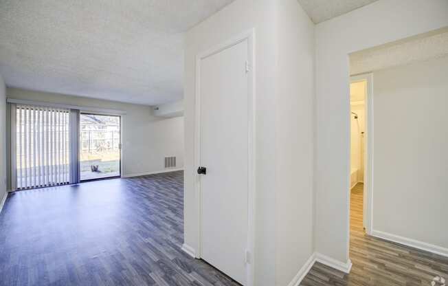 the spacious living room and dining room of an apartment