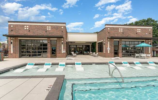 a brick building with a pool in front of it