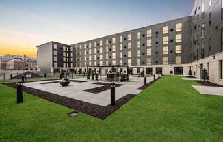 A modern building with a courtyard in front.