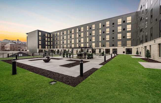 A modern building with a courtyard in front.