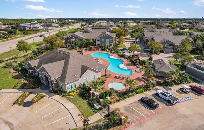 an aerial view of a neighborhood with a swimming pool and houses at Sladestone Shadow Creek, Texas
