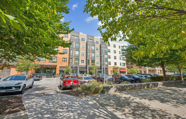 a city street with cars parked in front of a building at The Merc, Waltham, Massachusetts