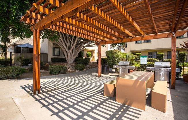 outdoor shaded seating area with grills