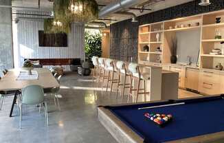 A pool table with a green cloth and a set of pool balls on it.