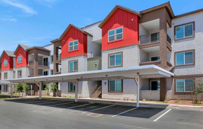 an empty parking lot in front of a row of apartment buildings at Weylyn Luxury Apartments, Arizona