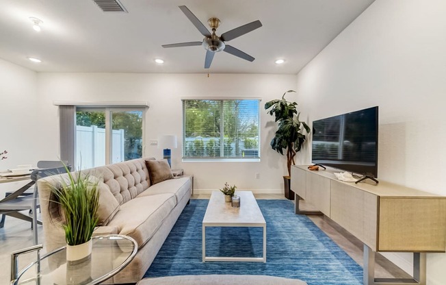 Boatman Hammock Townhomes in Lake Worth, FL photo of  a living room with a couch and a tv