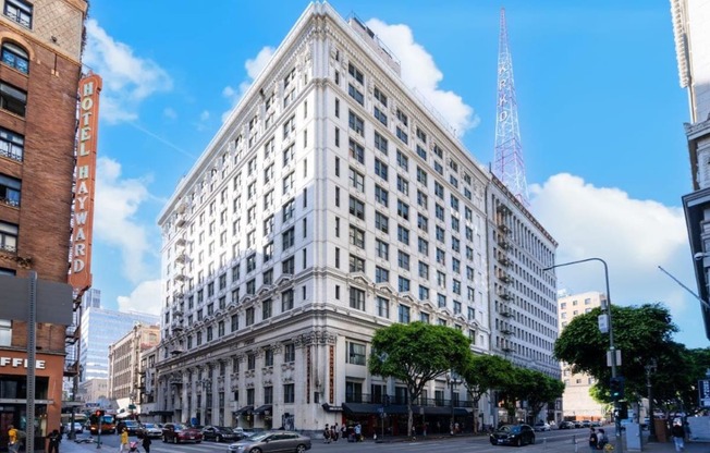 a large white building on the corner of a city street