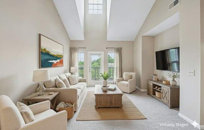 A living room with a large painting on the wall and a flat screen TV mounted above the entertainment center.