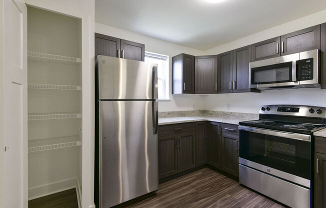 Kitchen with Window and Large Pantry at Dodson Pointe Apartment Homes, Rogers, AR, 72758