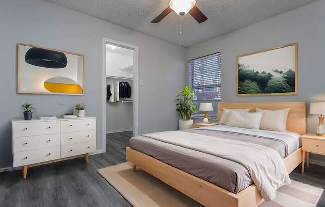 a bedroom with a bed and a ceiling fan