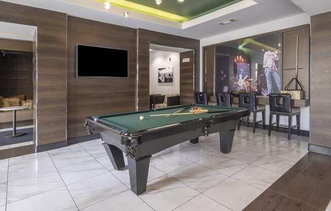 a billiards table in a game room with a tv at The Hendrix, Atlanta, Georgia