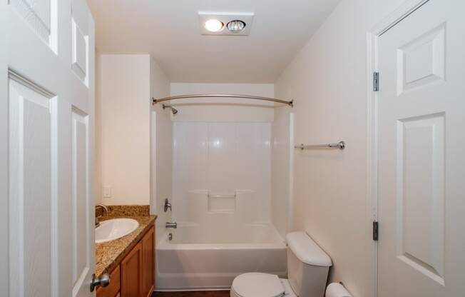 a bathroom with a toilet sink and bathtub