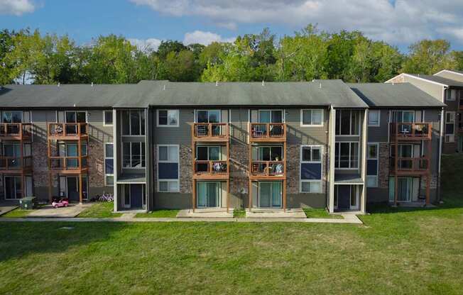 A large building with a green roof and a balcony on the second floor.