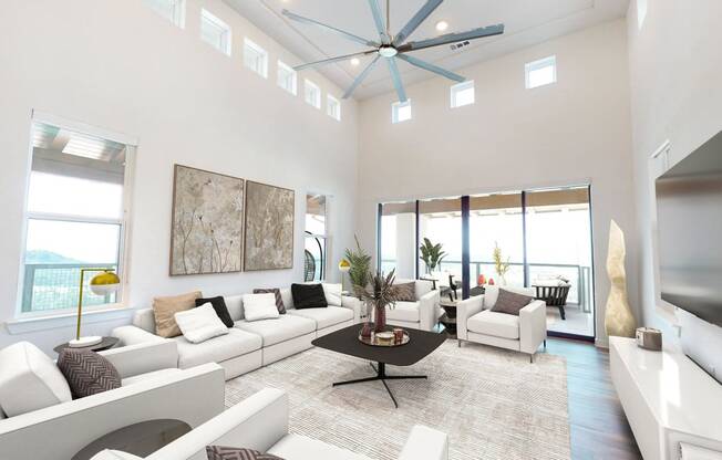 a living room with white furniture and a ceiling fan