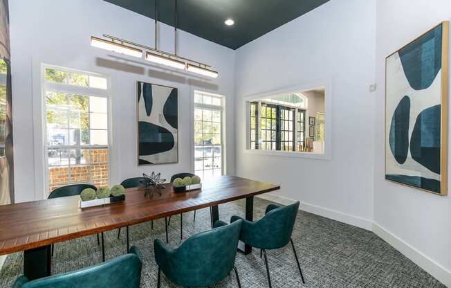 a dining room with a long wooden table and green chairs