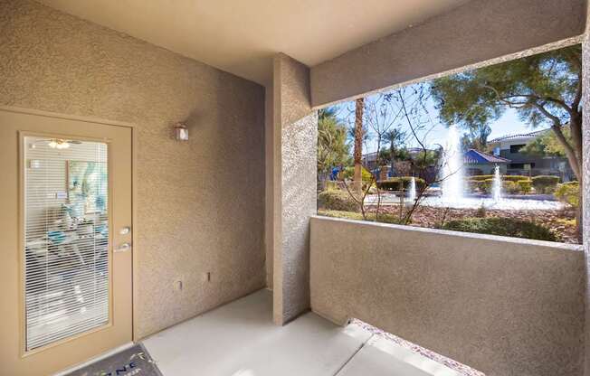 A view of a courtyard from a window in a room.