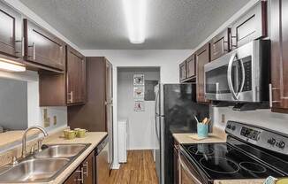 a kitchen with stainless steel appliances and wooden cabinets