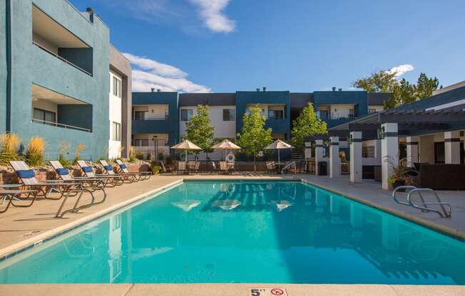 a swimming pool in front of an apartment building