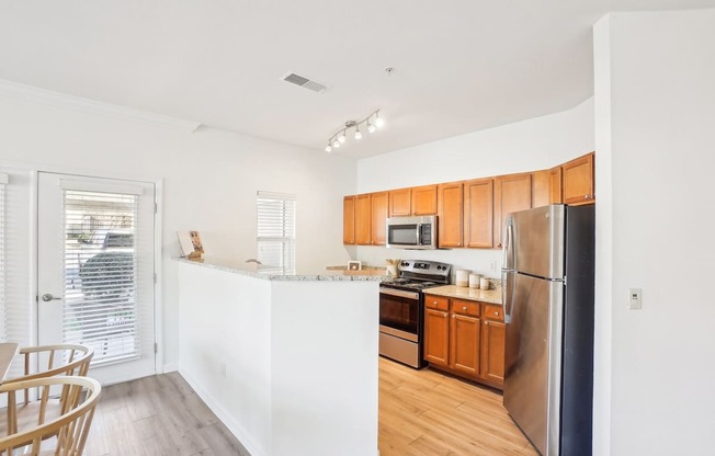 A kitchen with wooden cabinets and stainless steel appliances.