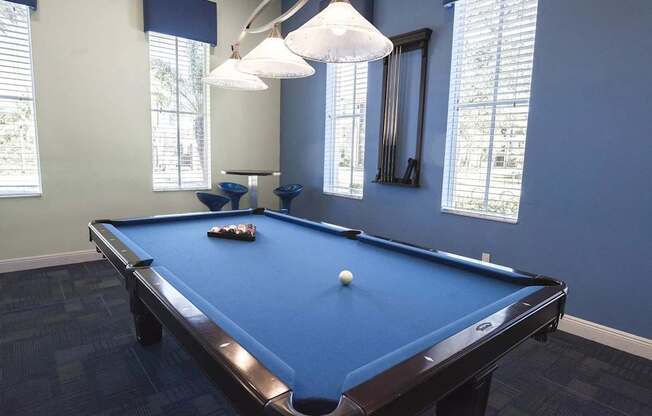 A pool table with a white ball on it.
