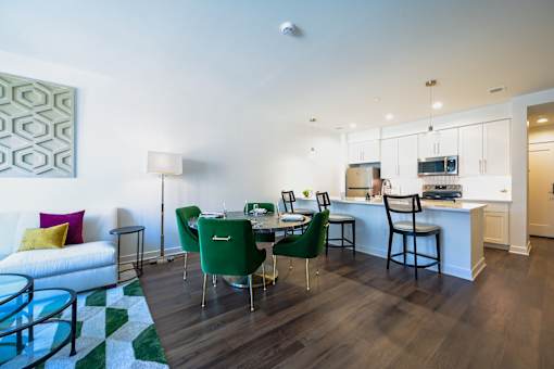 a living room and dining room with a table and chairs