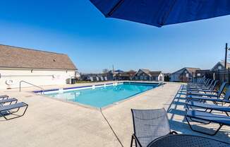 Affordable Antioch, TN Apartments – Hickory Lake – A pool surrounded by chairs and umbrellas.