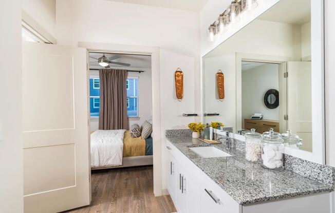 Bright and inviting bedroom retreat with direct access to your private bath at Beckett West Fork in Conroe.