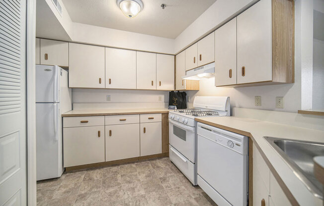 a kitchen with white appliances at Canal 2 Apartments, Lansing, 48917