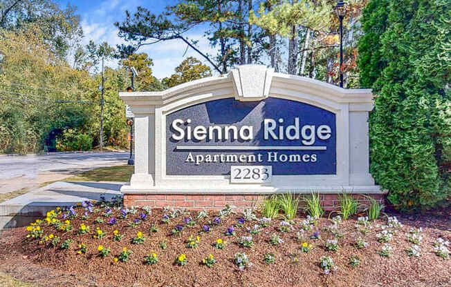 A sign for Sienna Ridge Apartment Homes with a number 2283 on it.