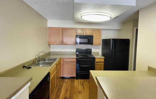 a modern kitchen with stainless steel appliances and wooden cabinets