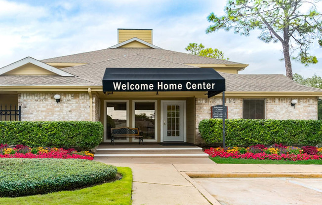 the entrance to the welcome home center in a brick building