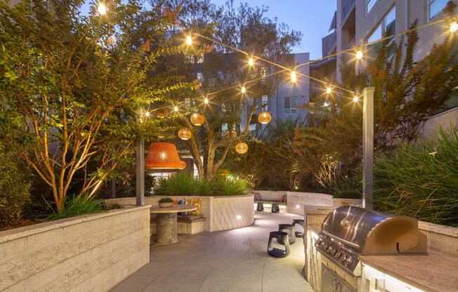 a patio with a barbecue grill and lights