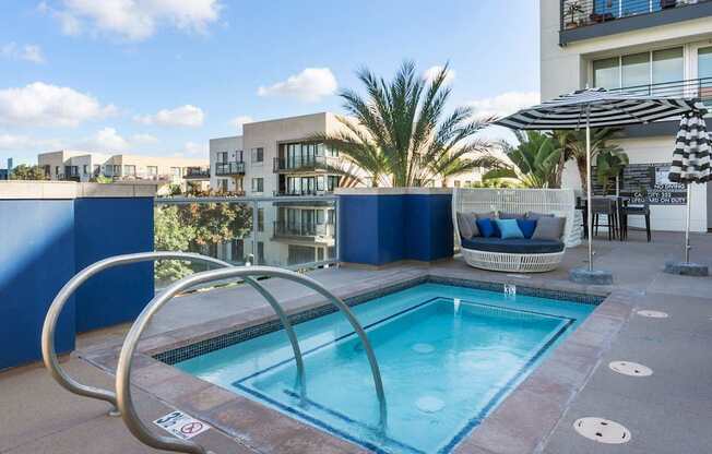 A small pool with a metal railing around it.