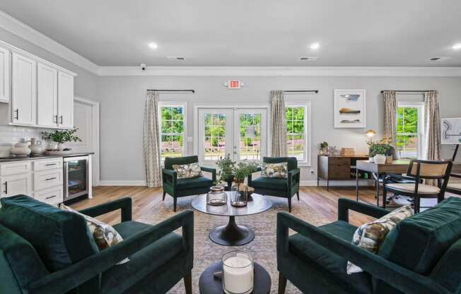 a living room with couches and chairs and a dining room with a table