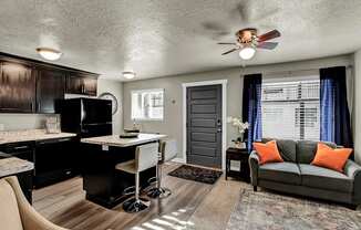 a living room with a couch and a kitchen