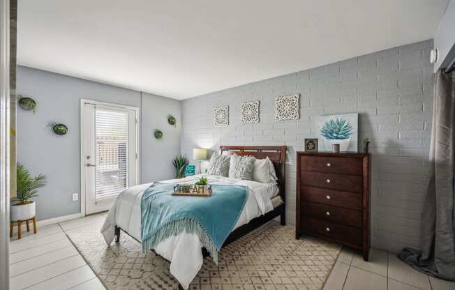 a bedroom with a bed and a dresser
