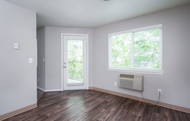 an empty room with a door and a window