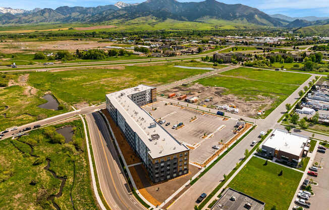 A large building with a parking lot in front of it.