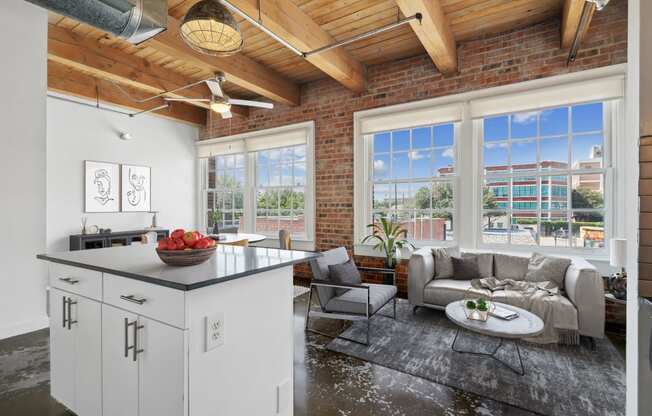 Murray Lofts Kitchen island and living room with large windows. Deep Ellum Lofts in Dallas, TX