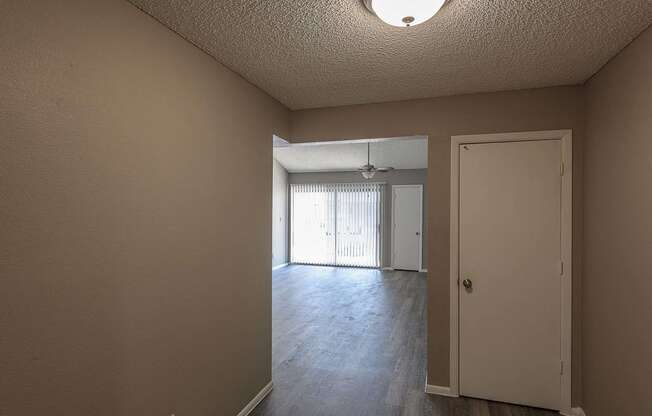 the living room and dining room of an empty house