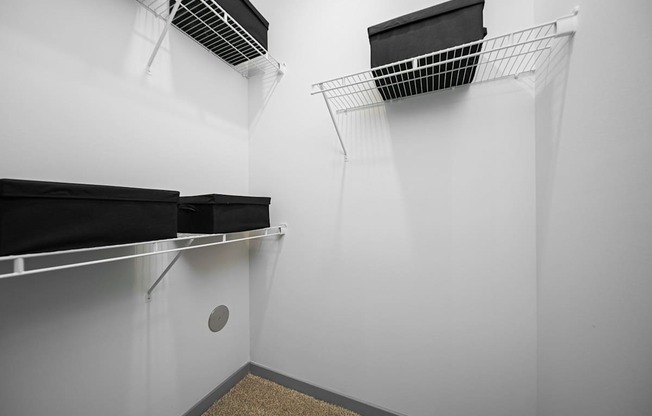 A storage room with two shelves and a ventilation system.